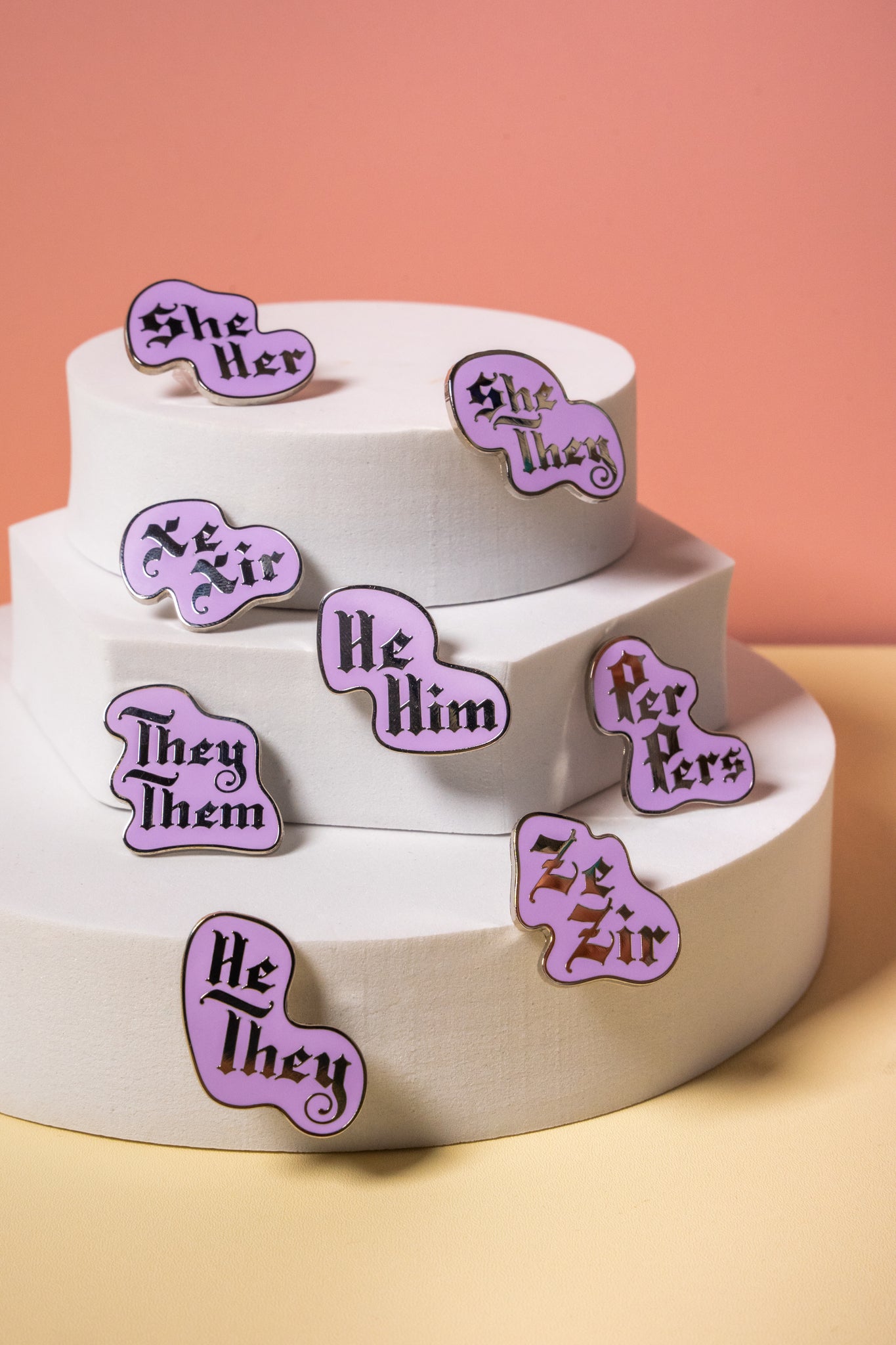 assorted pronoun pins on a display stand