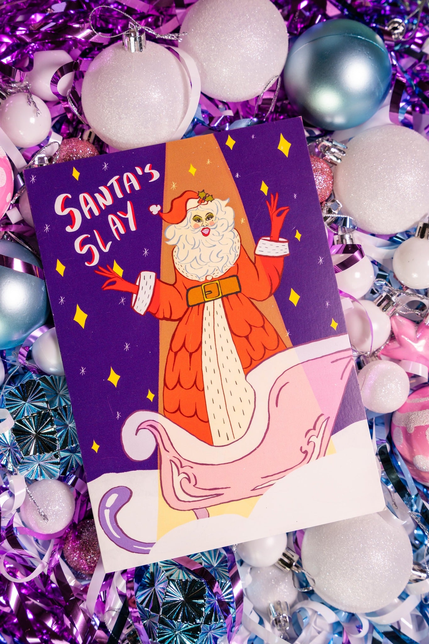 Card with Santa Claus illustration and 'Santa's Slay' text on a festive background with ornaments.