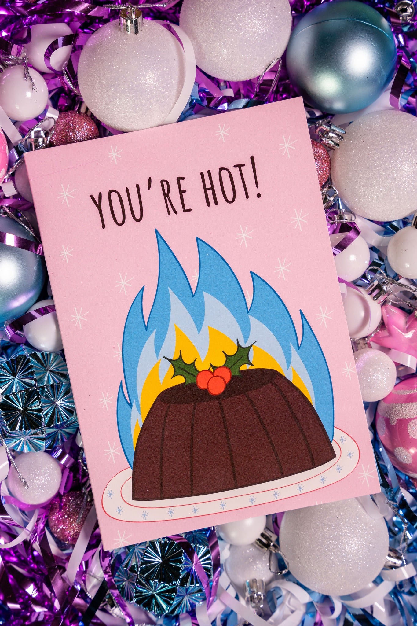 Card with a flaming christmas pudding design and text 'You're Hot!' on a colorful background