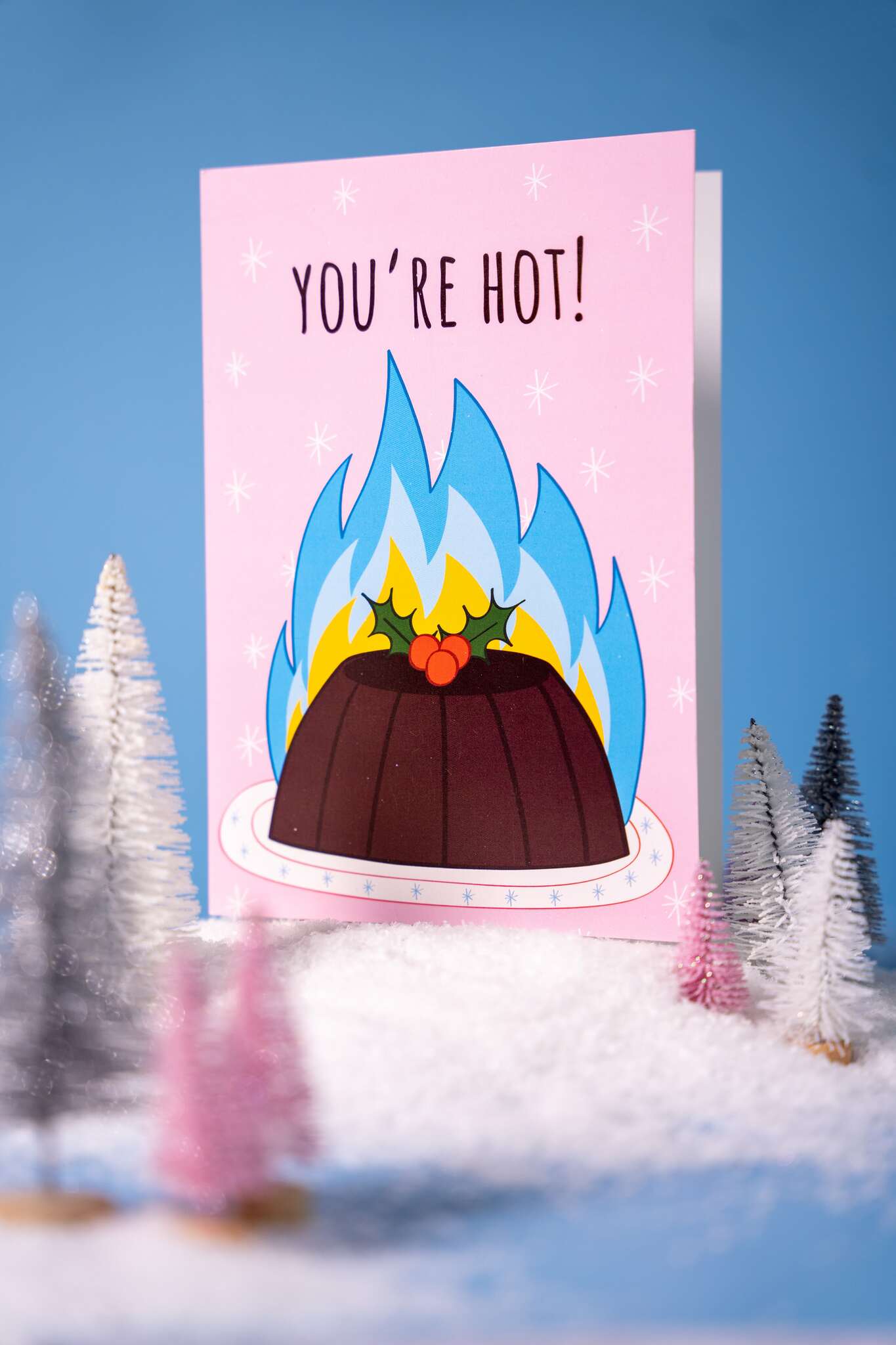 Card with a flaming christmas pudding illustration and 'You're Hot!' text on a blue background