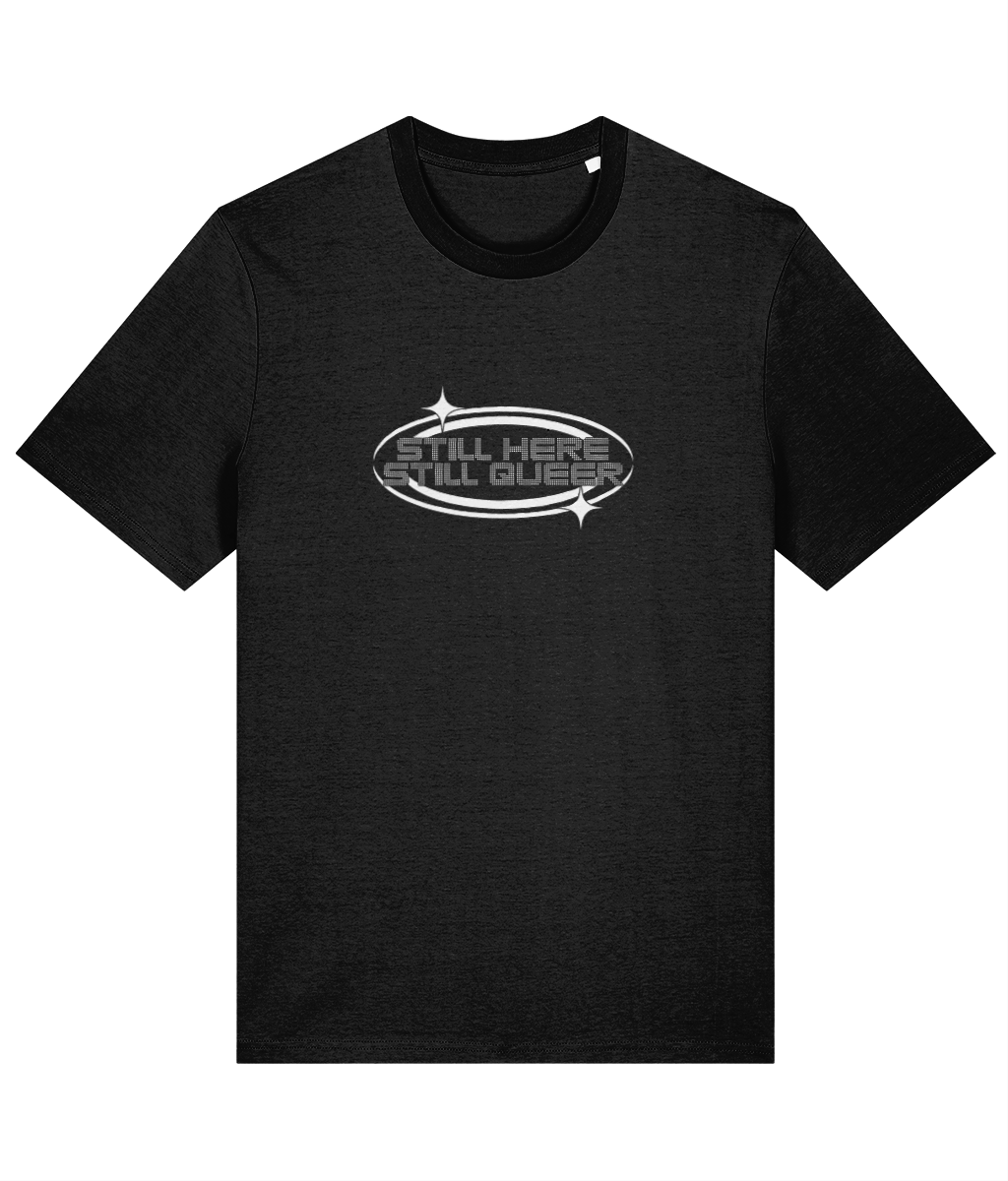 Black t-shirt with 'Still Here, Still Queer' text on a white background